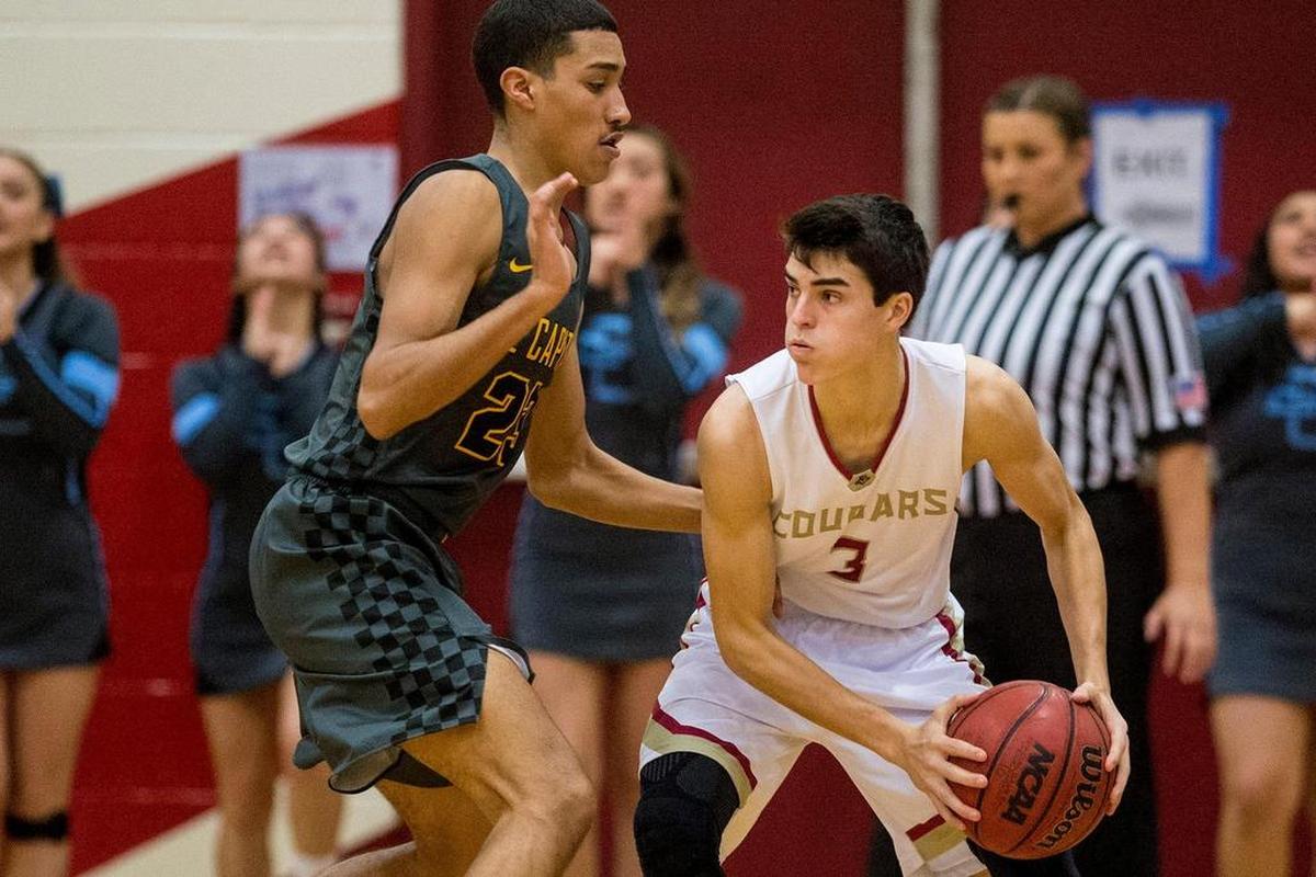 Golden Valley senior Bryan Livesay (3) is guarded by El Capitan senior Abraham Esquivel (23) during a game at Golden Valley High School in Merced, Calif., on Wednesday, Jan. 23, 2019.