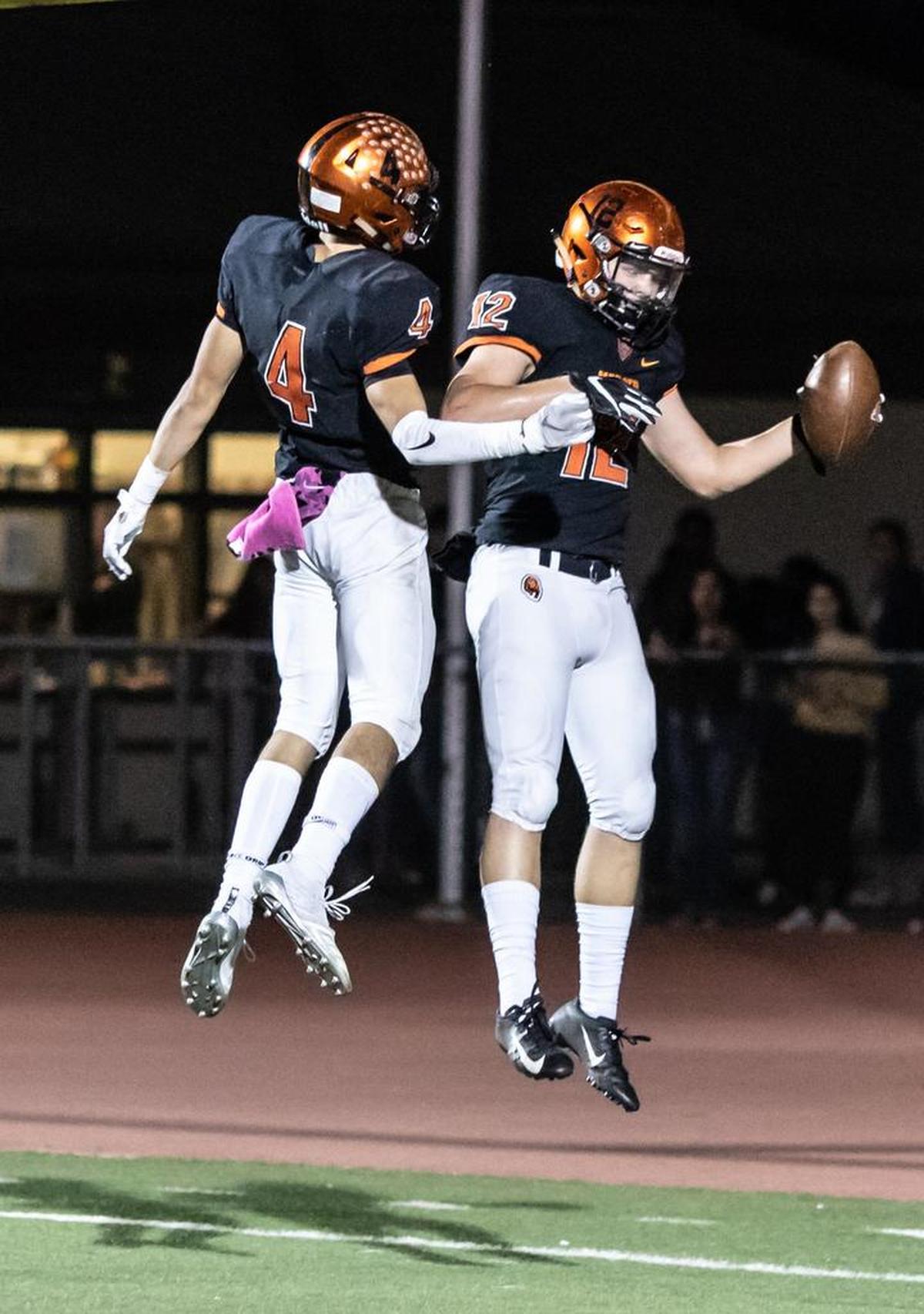Merced’s Ezra Morales (4) celebrates with teammate Bobby Hopkins after Hopkins scores on a 32-yard touchdown reception from Dhameer Warren in the third quarter of the Bears’ 41-7 win over Golden Valley on Friday night at Veterans Stadium.