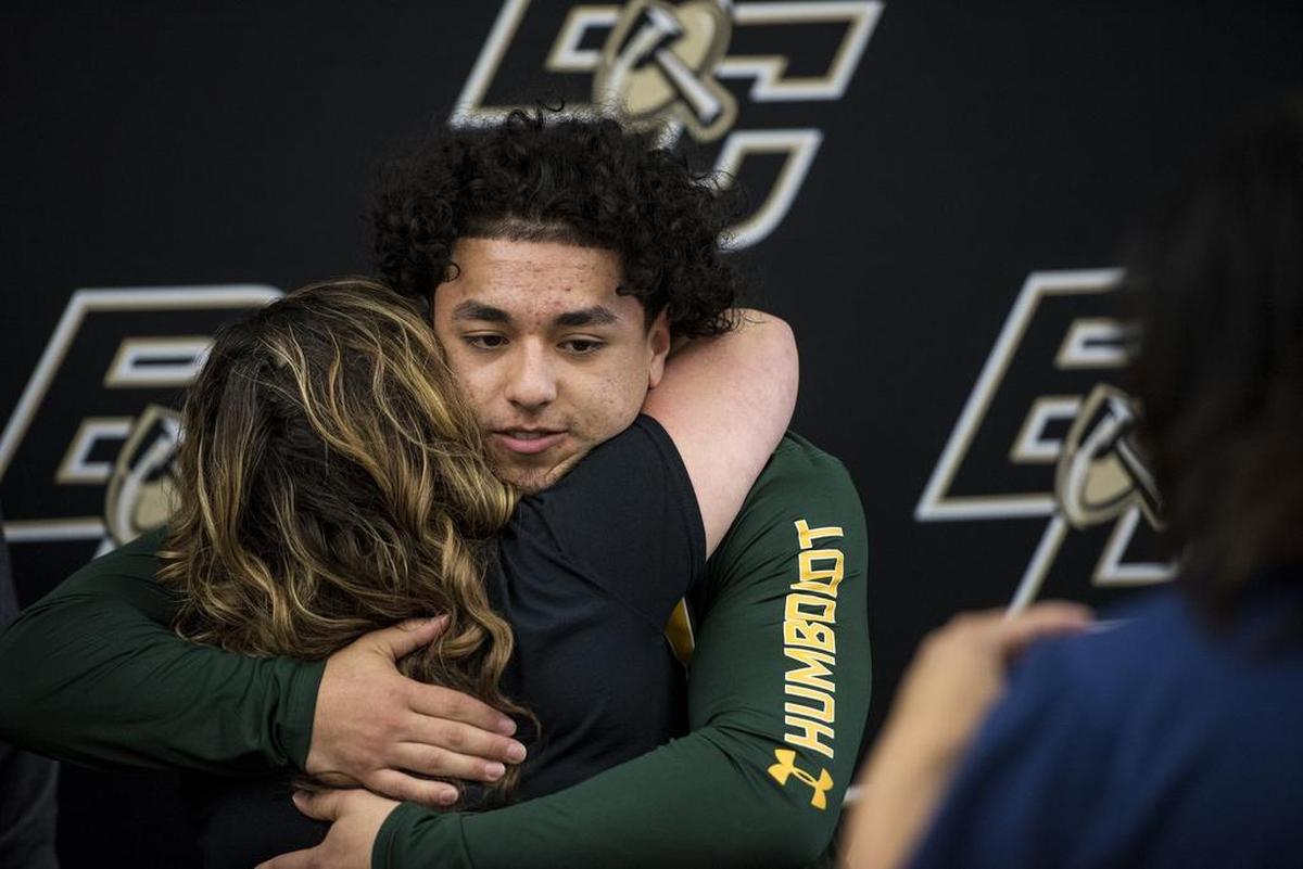 Buhach Colony senior Christian Quirarte hugs his mother Rosie after signing his letter of intent to attend Humboldt State University, at Buhach Colony High School in Atwater, Calif.,. on Thursday, March 8, 2018.