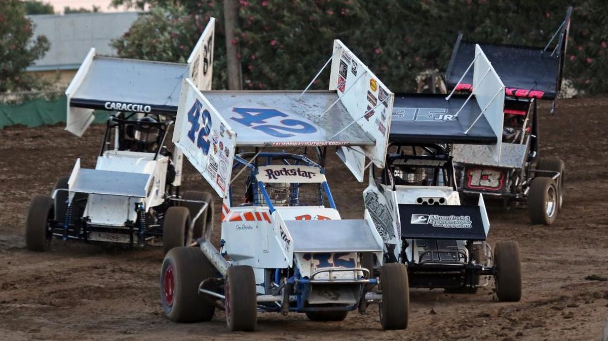 Jon Robertson leads pack of BCRA Midget Lites out of turn two at Merced Speedway during the Fourth Annual Wayne Albright Memorial last year. Wayne’s son, Dakota Albright, right, challenges Robertson for the lead from inside as does Charlie Caraccilo in taking the outside lane. Caracillo snatched victory from Albright in last year’s Wayne Albright Memorial. Photo by Mike Adaskaveg