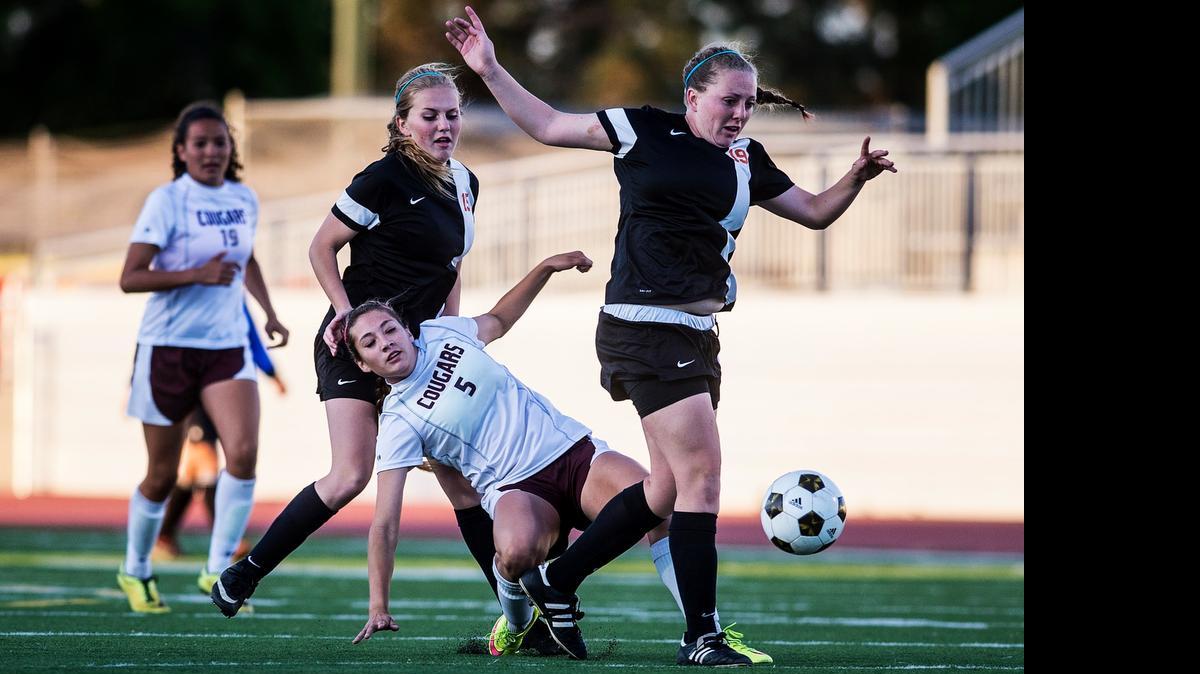 Golden Valley sophomore Megan Pust (5) gets caught between Merced’s   Baylee Lawry and Lawry’s sister Taylor, right, in an April 14 game at Golden Valley High School.