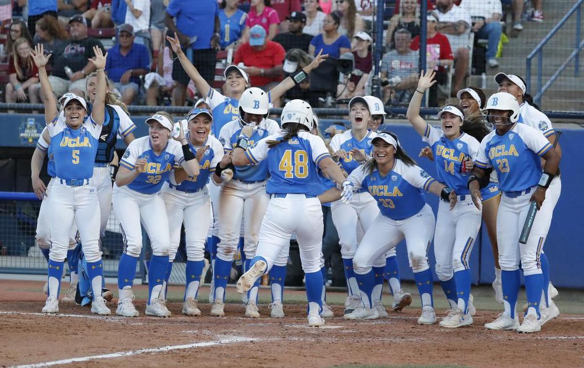 UCLA celebrates as Bubba Nickles (48) comes home after a home run against Oklahoma in the sixth inning of the first game of the best-of-three championship series in the NCAA softball Women’s College World Series in Oklahoma City, Monday, June 3, 2019. (AP Photo/Alonzo Adams)