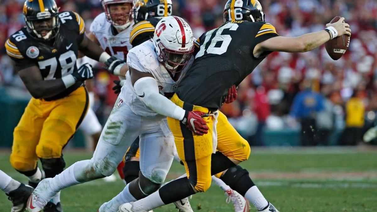 Stanford defensive end Aziz Shittu, left, awaits to hear if his name will be called on draft day after showing the NFL scouts what he could do at the Cardinal pro day last week.